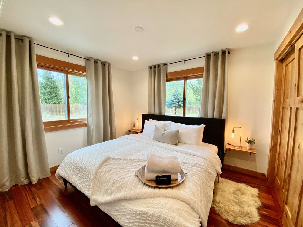 Main floor bedroom with a king bed at The Cascade Chalet