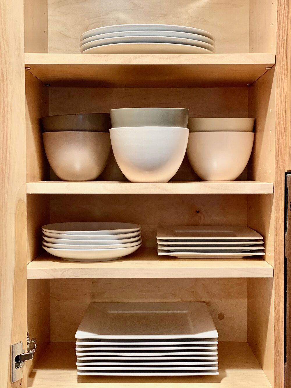 Open shelving stacked with plates and bowls in the kitchen at The Cascade Chalet