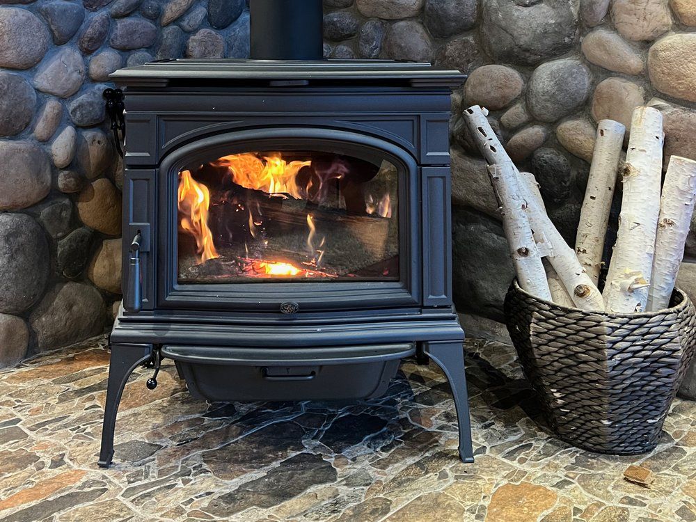 Lit wood stove with birch logs in the living room