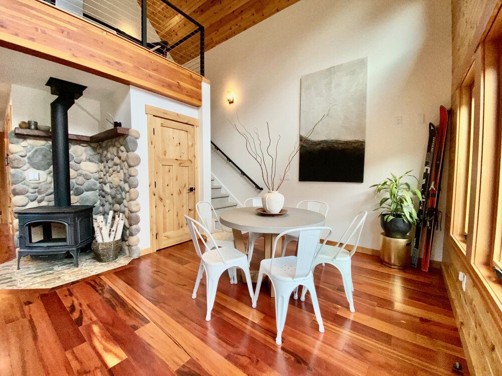 Dining area beside the wood stove with stairs to the loft