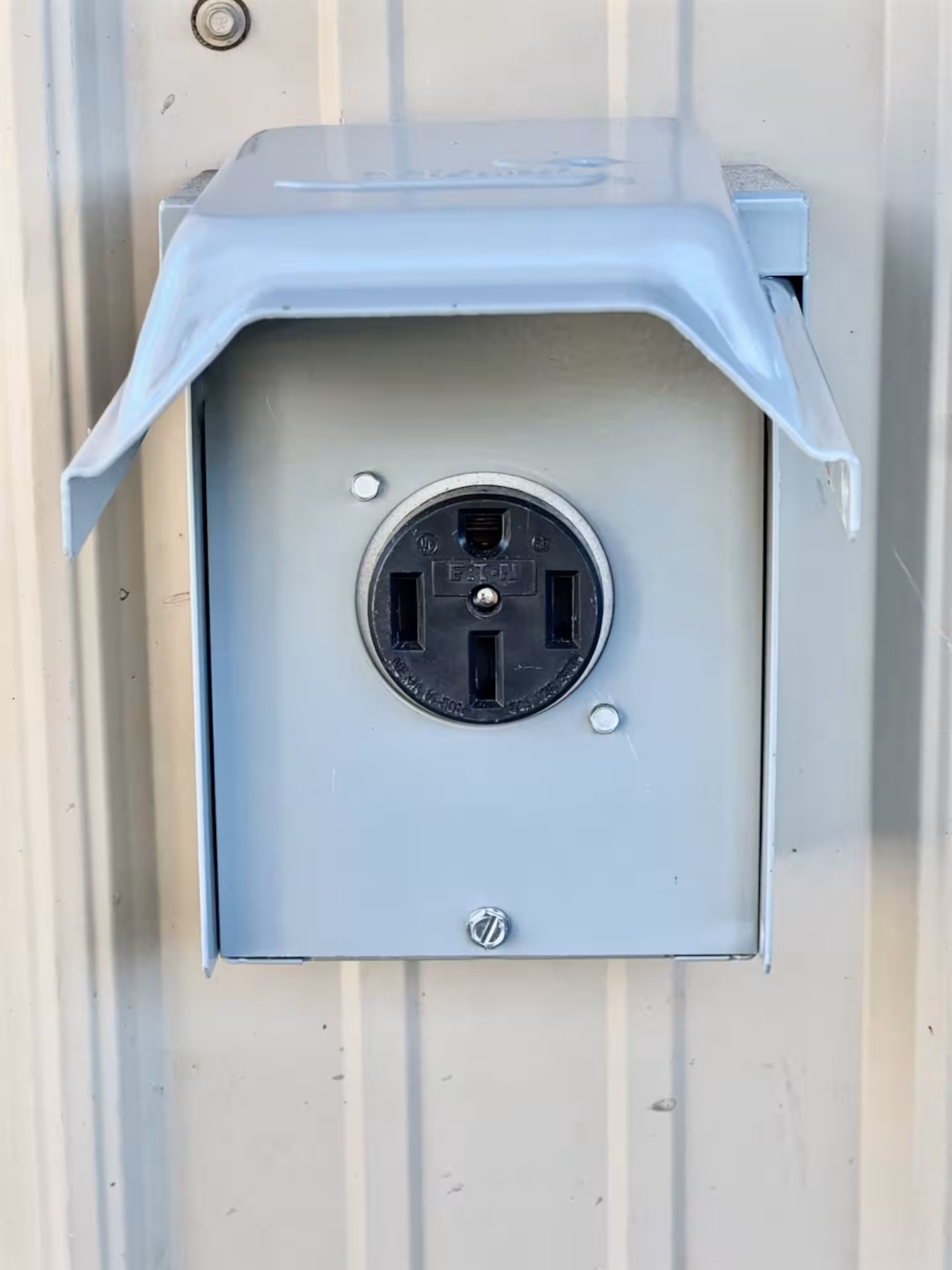 NEMA 14-50 240-volt outlet in a weatherproof box on the exterior of The Cascade Chalet for electric vehicle charging
